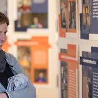 A woman smiles while enjoying the exhibit